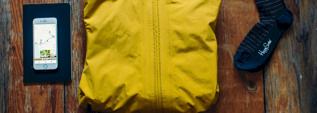 camping clothing with hat gloves jacket laying table