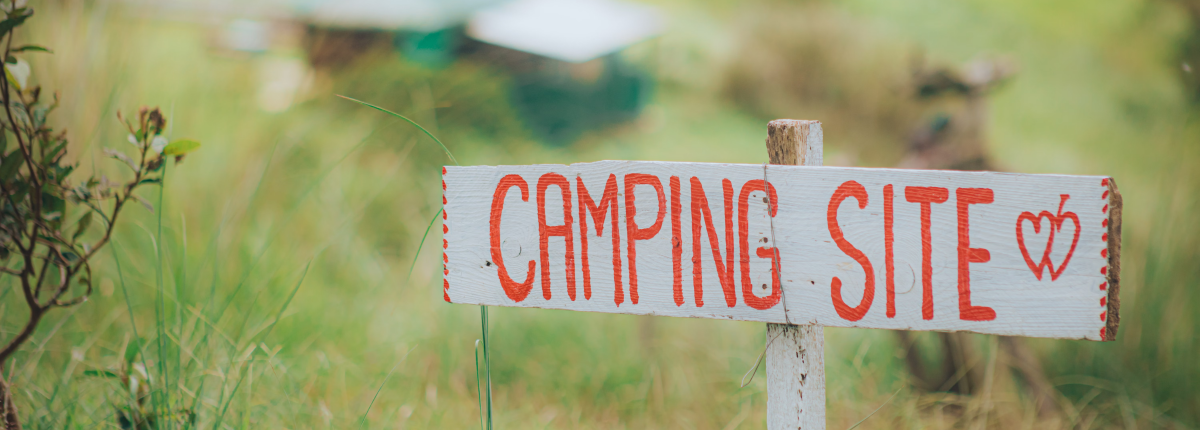 a camping site grass field with sign