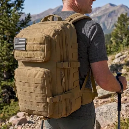 man hiking to camping site wearing a tactical backpack and sling bags