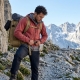 climber adjusting their durable, lightweight backpack on the rocky alpine trail.