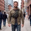 man walking on sidewalk in an urban city wearing an EDC fanny pack in black