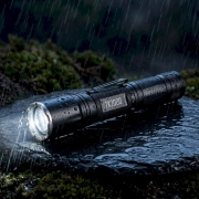 waterproof camping flashlight flashlight in rain on rock at night