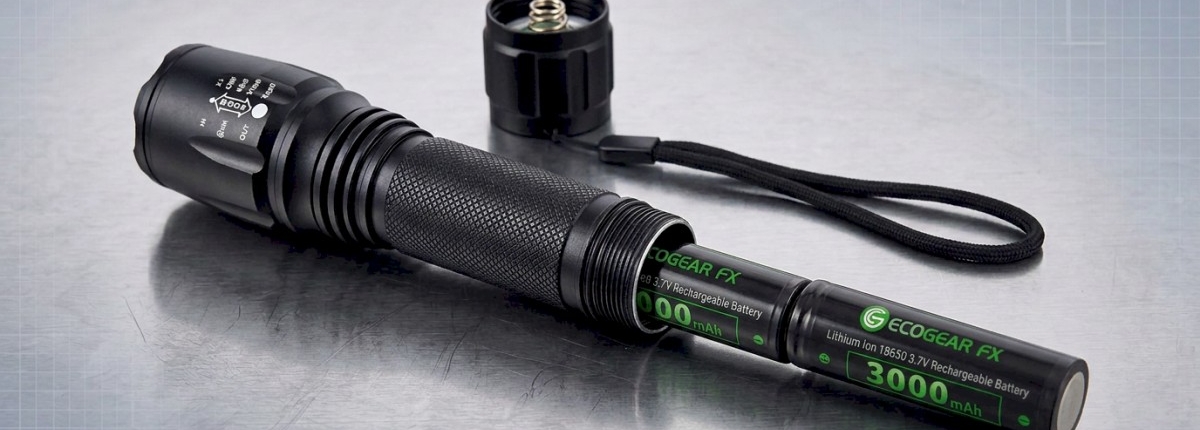 flashlight on a table with the batteries inserted with the tail-cap off