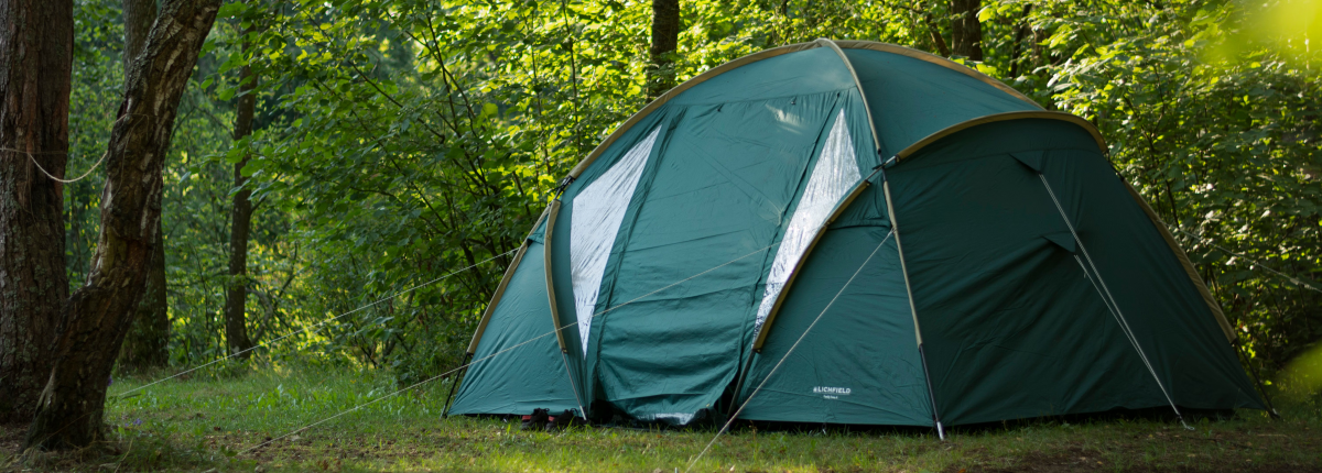 four‑seasons tent on forest ground