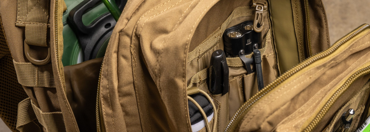 large tactical backpack on floor with all compartments open