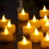 a group of LED Flameless Candles on a table during the evening