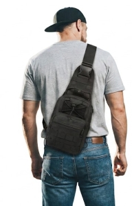 man wearing a sling chest bag with hat while walking