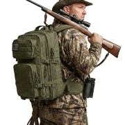 man wearing a tactical backpack while hunting