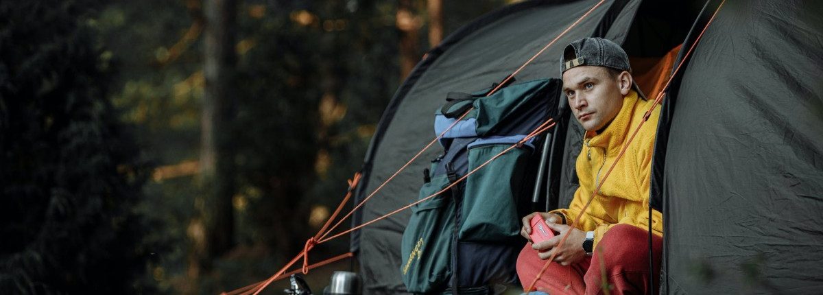 Weather‑Resistant Tent in the Forest with Man Inside