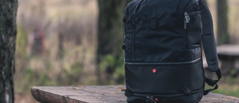 small gear bag sitting on top of bench in camp site