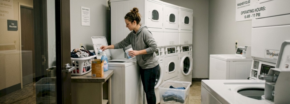 Person doing laundry in a hotel laundry room