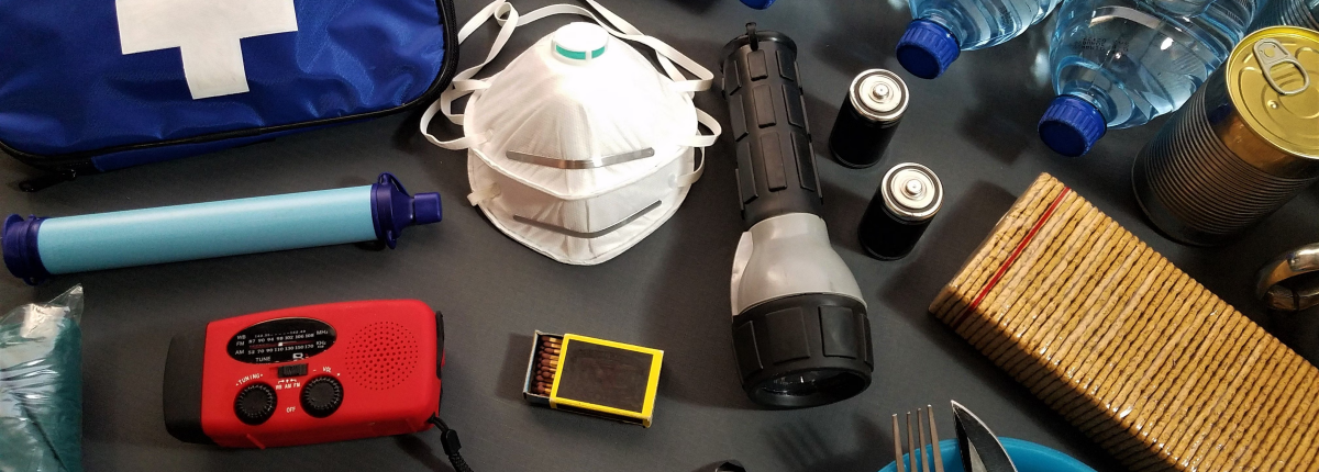 various safety and first aid kit items with radio and emergency blanket