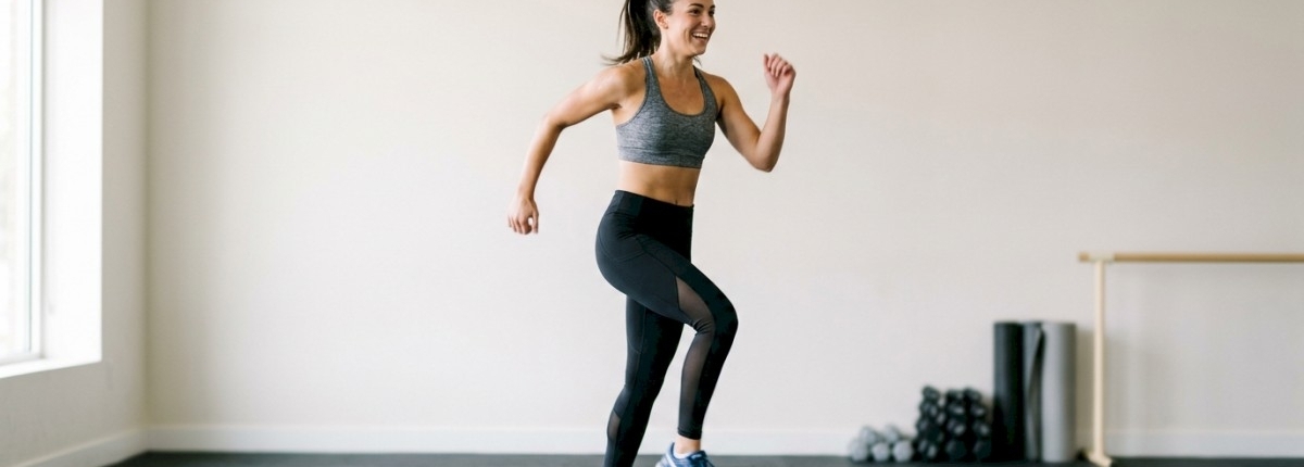 woman doing aerobic exercise on a stepper in an exercise room